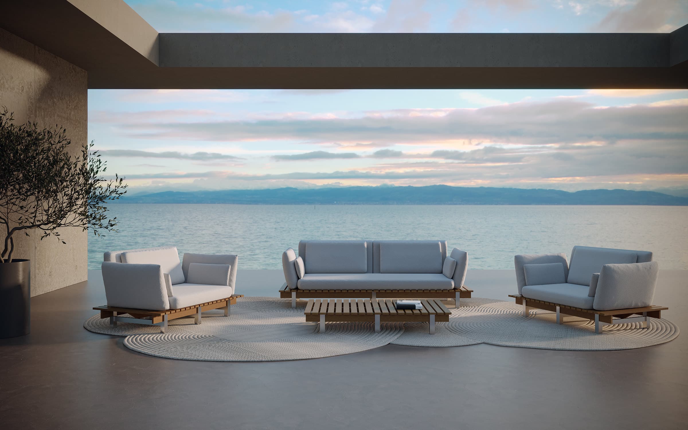Sillones y mesas de exterior Sierra en una terraza frente al mar