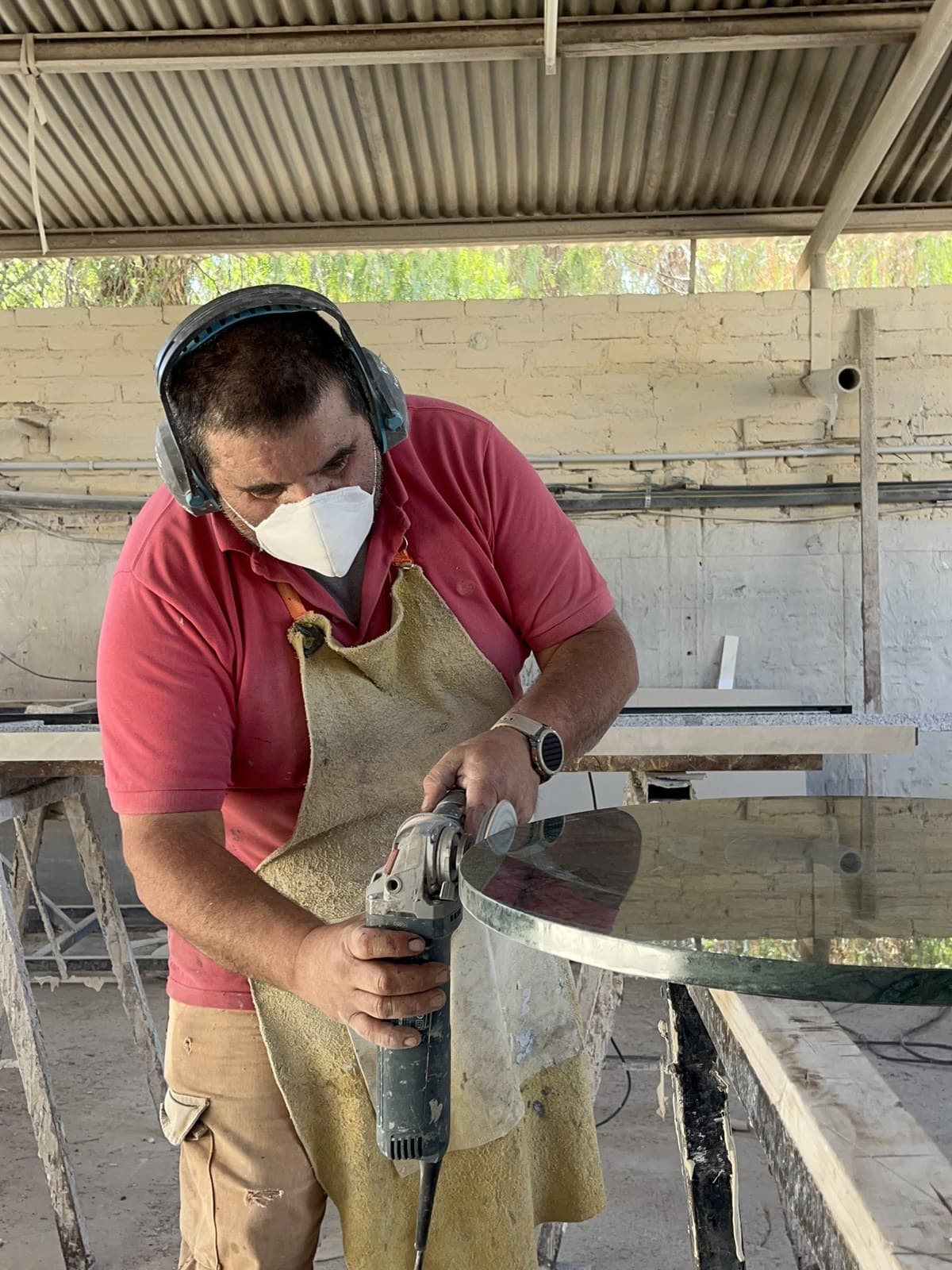 Operario de Puro Mármol puliendo el canto de una pieza con amoladora